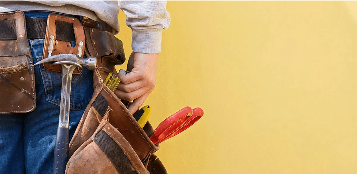 Handyman with tool belt ready for home repairs and maintenance in Los Angeles, CA