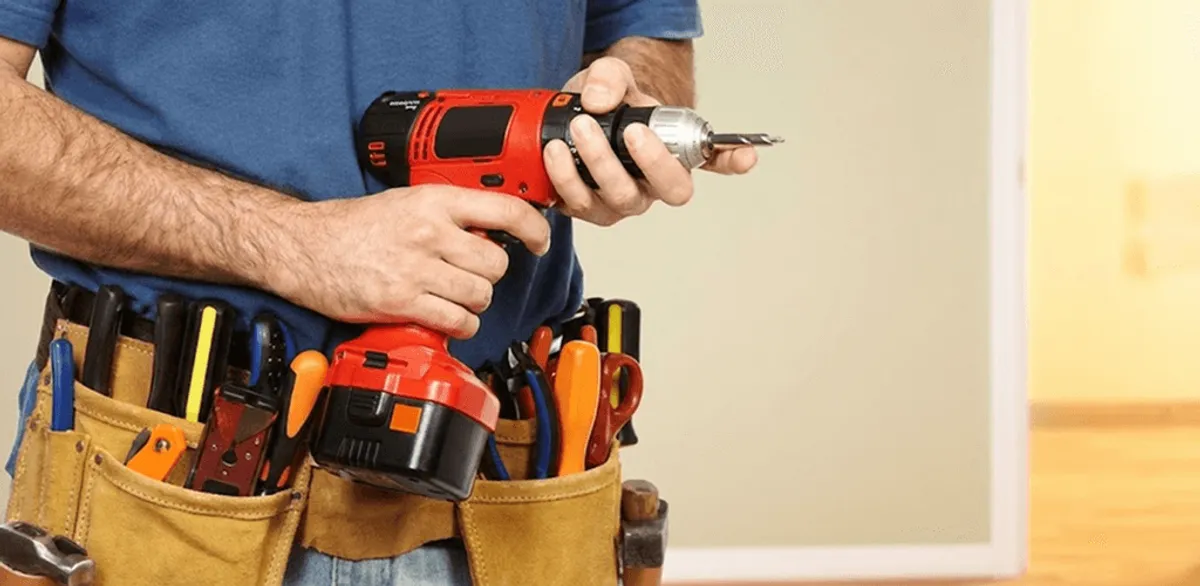 Handyman holding a power drill for home repairs and installations in Los Angeles, CA